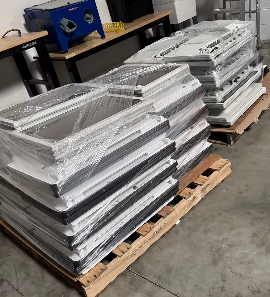 Stacks of surgical displays wrapped and arranged on pallets in the Infinity workshop